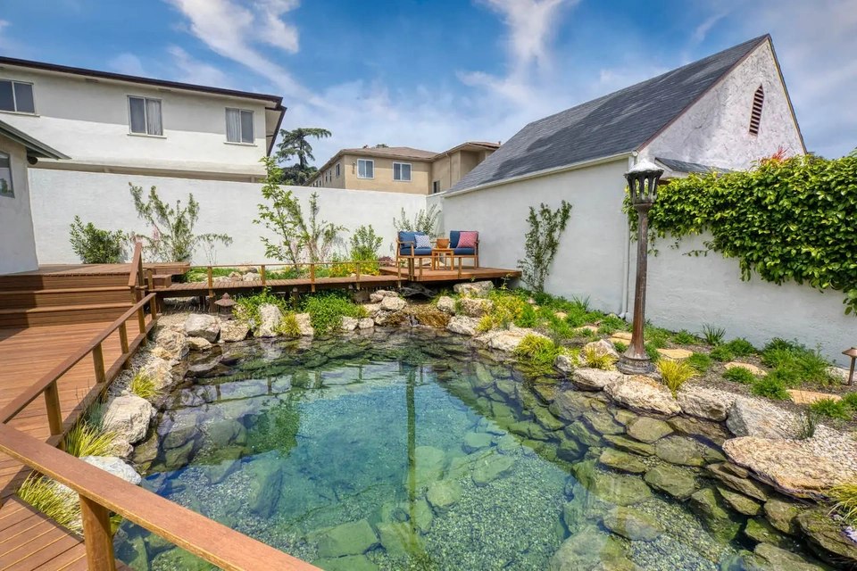 Japanese style large outdoor pond with overhanging observation deck.